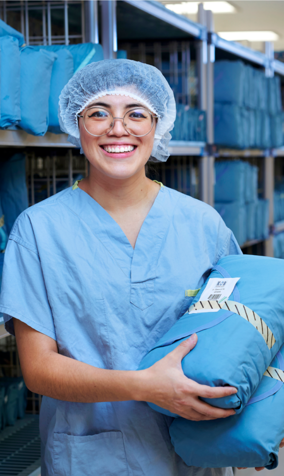 A happy K-Bro employee with operating room bundles
